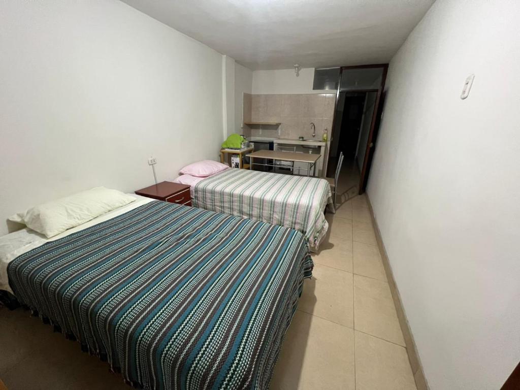 En eller flere senge i et værelse på Centro de Tacna