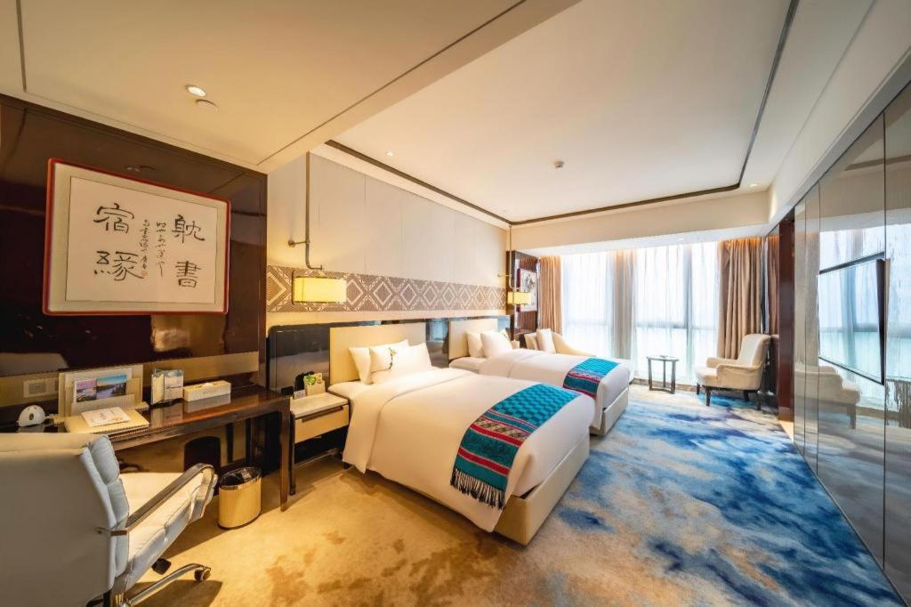 Ένα ή περισσότερα κρεβάτια σε δωμάτιο στο Hou Yi Grand Hotel