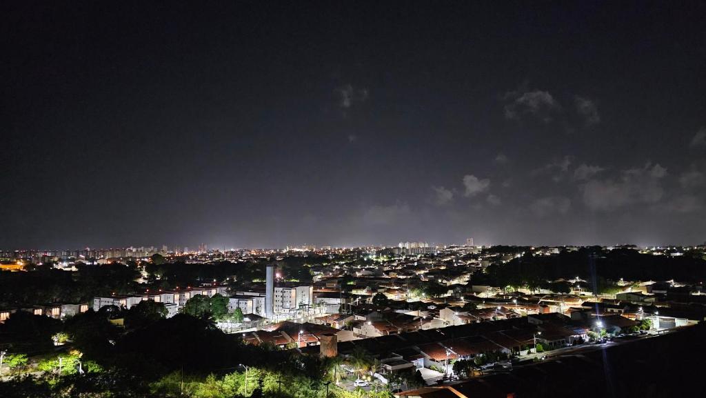 a view of a city at night with lights at Suítes centro histórico e praias in São Luís