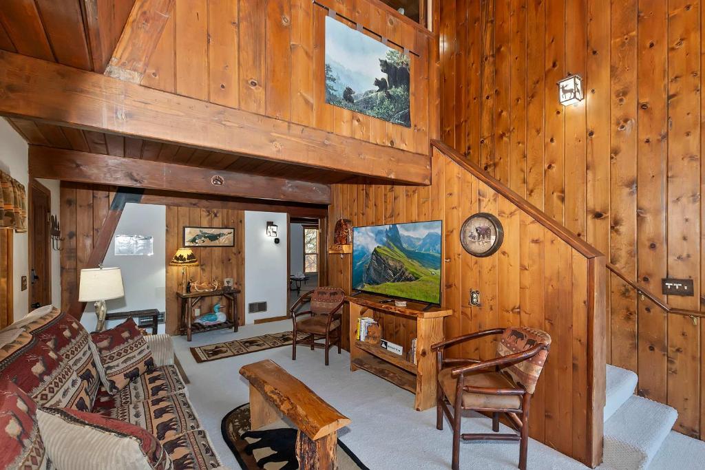 a living room with wood paneled walls and a ceiling at Yosemite Pines Cabin - Sleeps 6 in Big Bear Lake