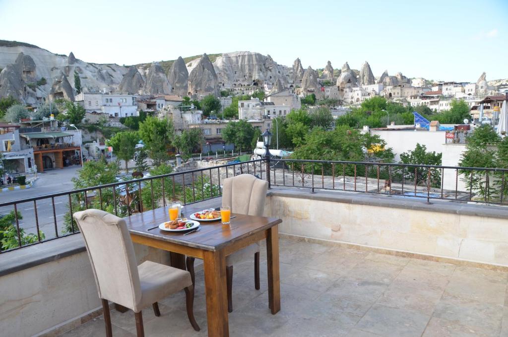 a table and chairs on a balcony with a view at Yusuf Bey House in Göreme