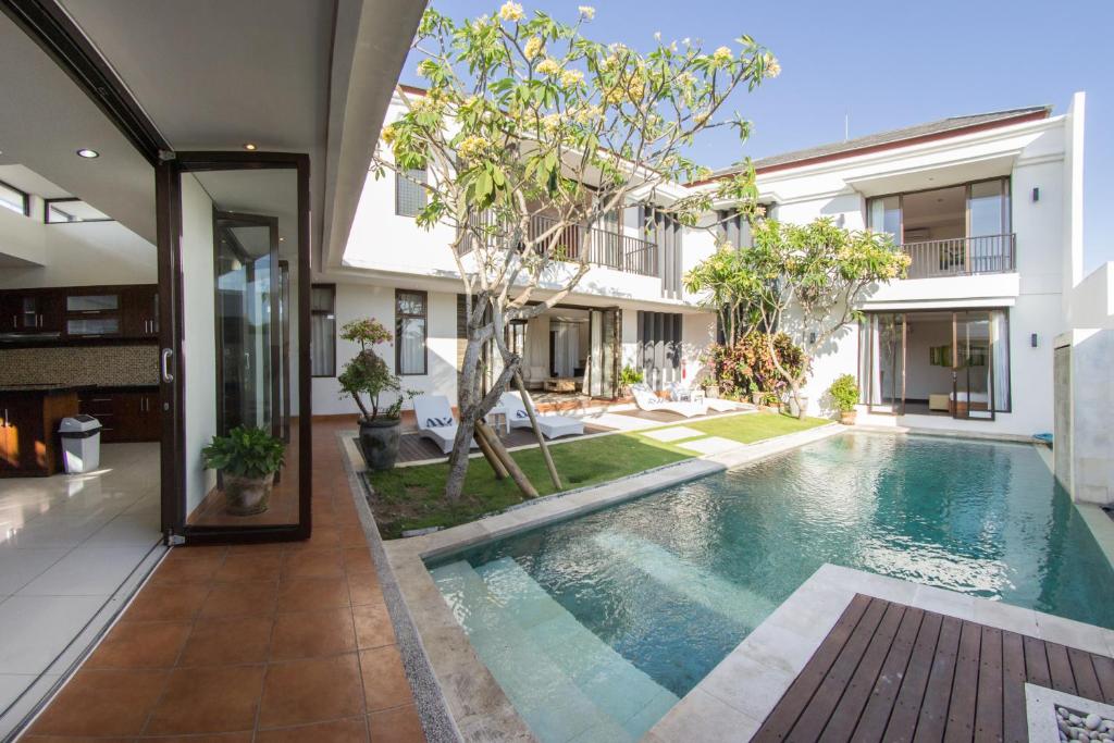 an external view of a house with a swimming pool at Villa Uma Girasole in Canggu