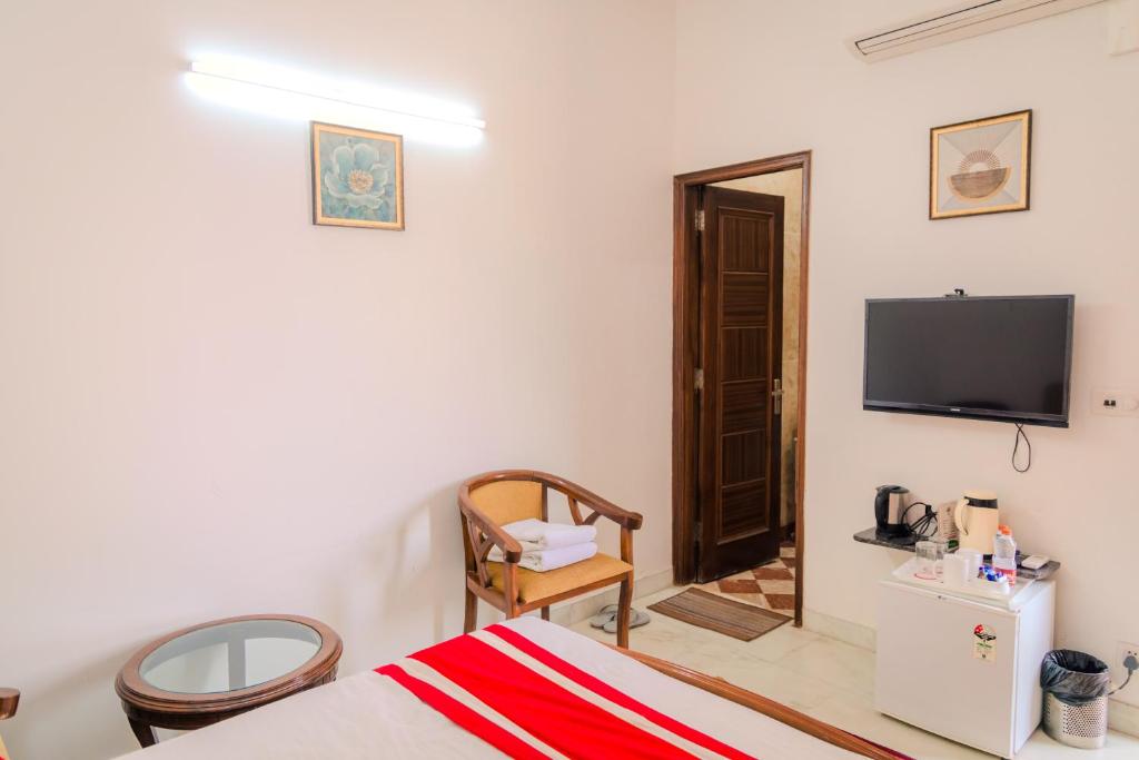 TV a/nebo společenská místnost v ubytování Peepal Tree Residency