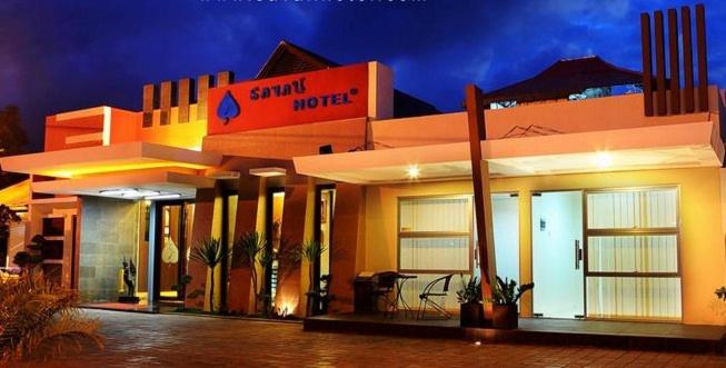 a large building with a sign on the side of it at Savali Hotel in Padang