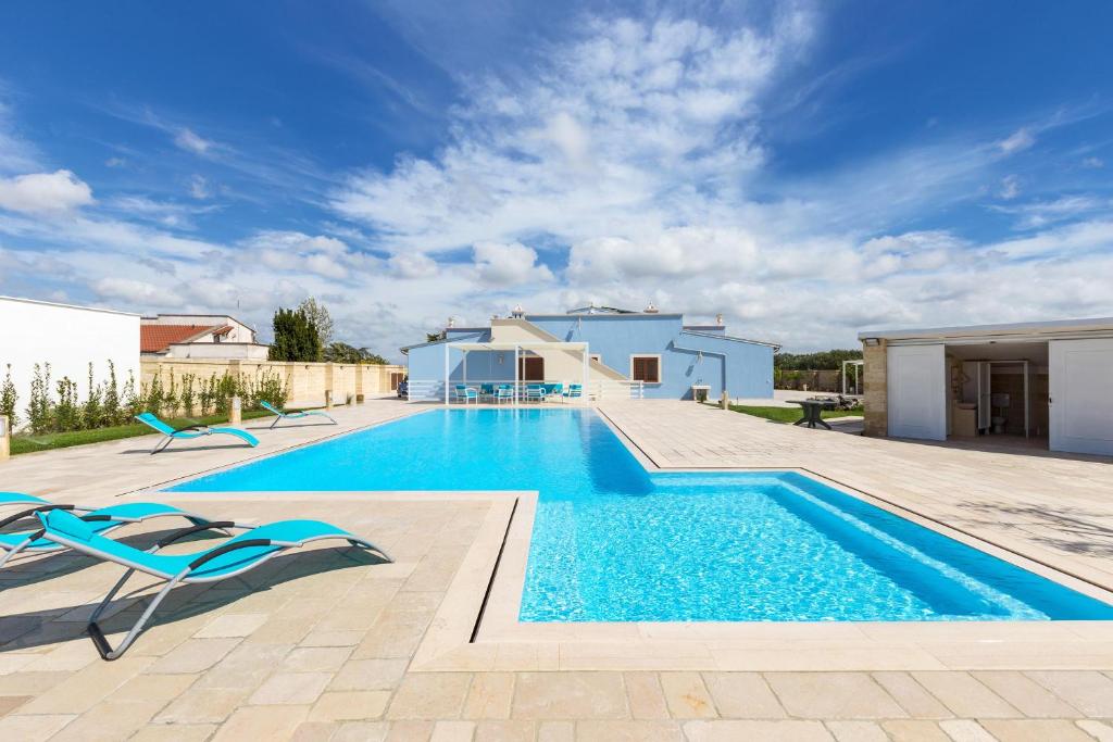 a swimming pool in a villa with a blue at Villa Vincenti by BarbarHouse in Ruffano
