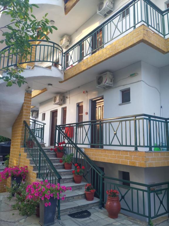 an apartment building with stairs and potted plants at Panorama in Kallithea Halkidikis