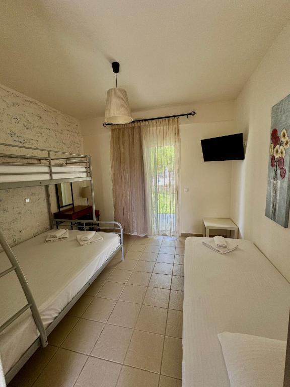 Postel nebo postele na pokoji v ubytování Dafnes Rooms