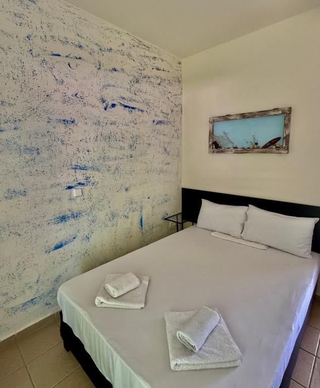 Postel nebo postele na pokoji v ubytování Dafnes Rooms