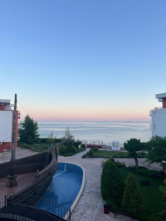 a view of a swimming pool and the ocean at Fort Noks with sea view in Elenite
