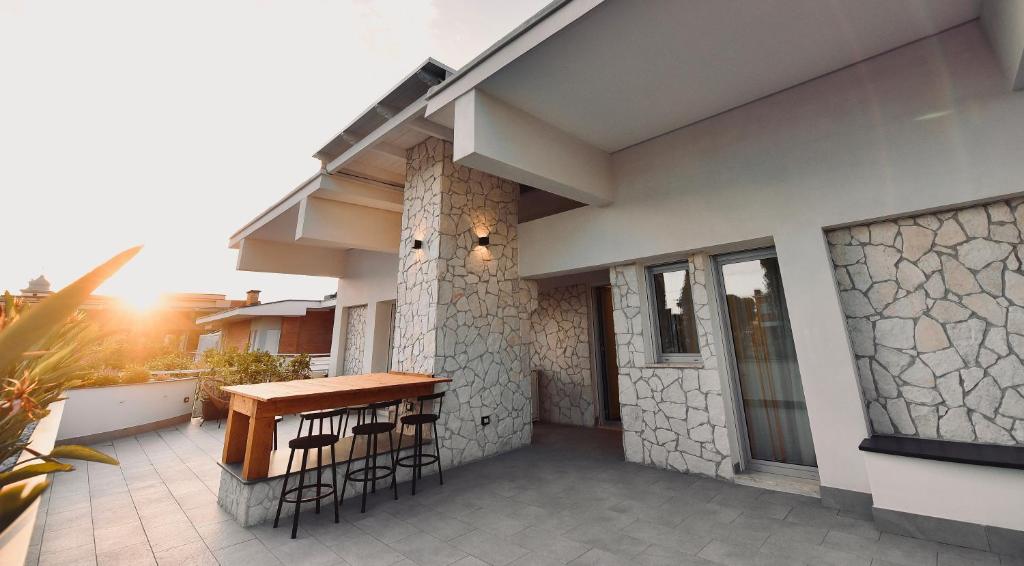 a house with a table and chairs on a patio at Ciotola Apartment 5 minuti dall' Aeroporto di Napoli in Naples