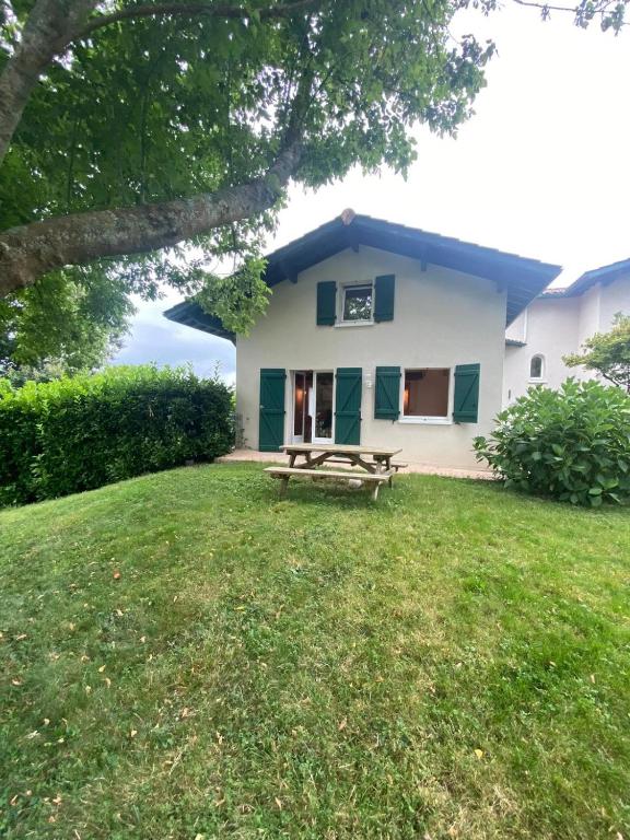 une maison avec un banc de pique-nique dans la cour dans l'établissement Maison mitoyenne au coeur du Pays Basque proche mer, montagne, à Mendionde