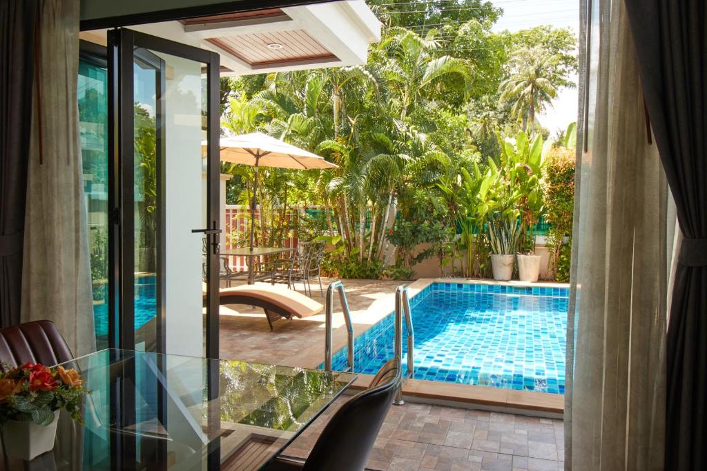a view of a swimming pool from a house at Baan Ping Tara Tropical Pool Villa and Scooter in Ban Khlong Son