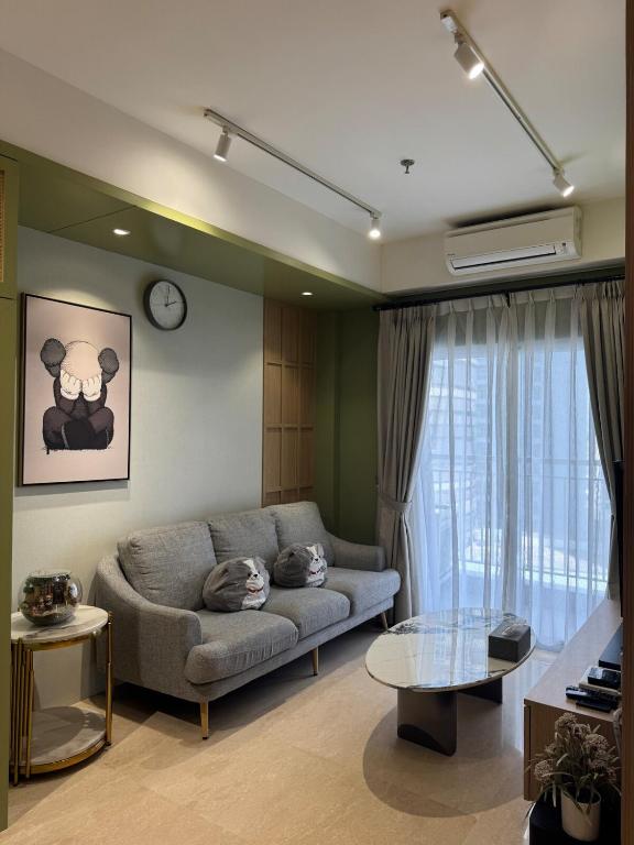 a living room with a couch and a table at Japandi Serenity 1 king,1 queen,1 single bed 5pax in Medan