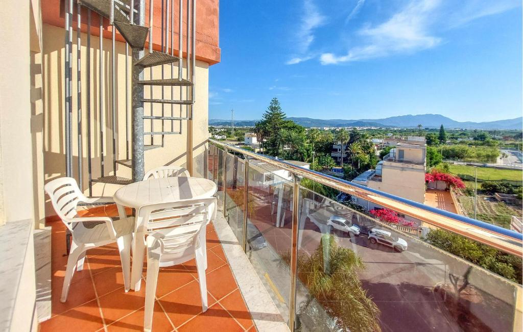 a balcony with a table and chairs and a view at Awesome Apartment In Bellreguard in Bellreguart