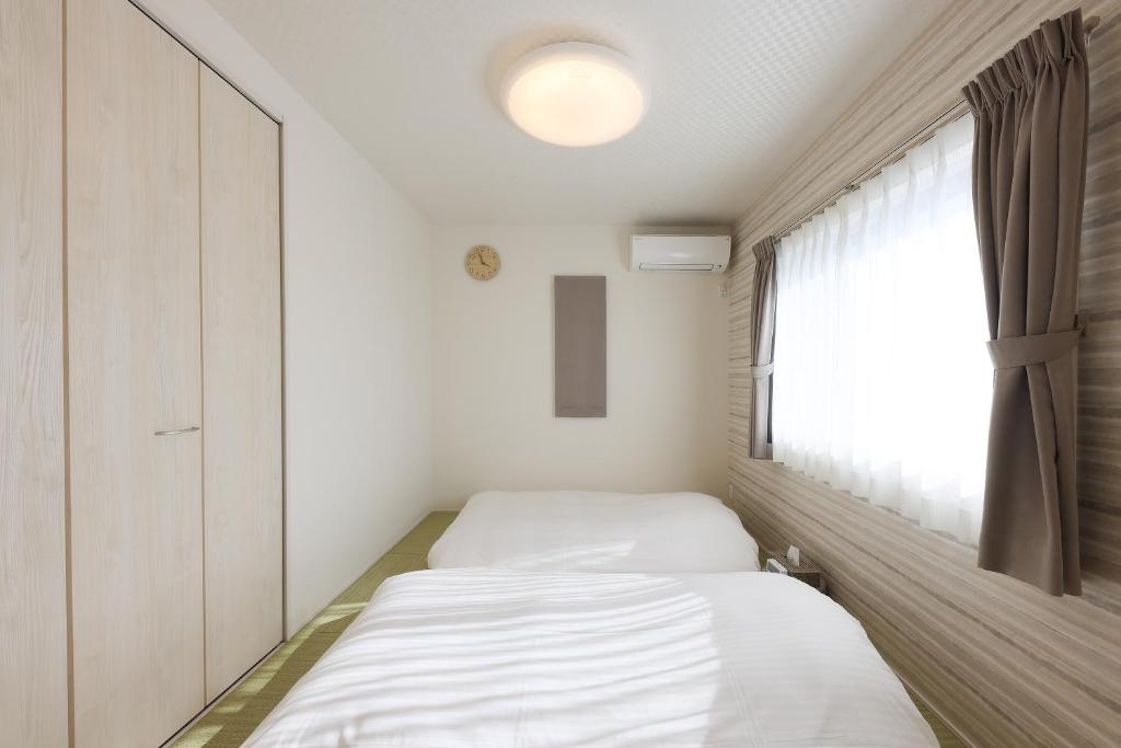 Postel nebo postele na pokoji v ubytování Angler’s Resort Awajishima
