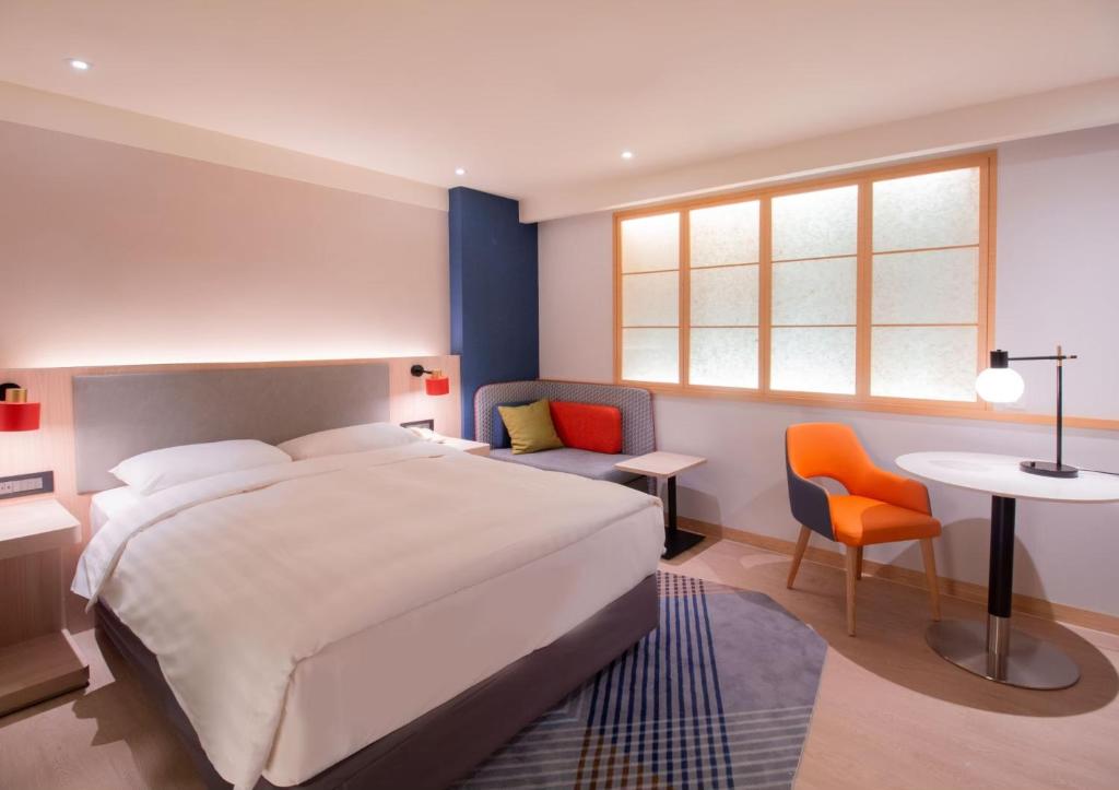 Postel nebo postele na pokoji v ubytování Holiday Inn Express Taipei Train Station by IHG