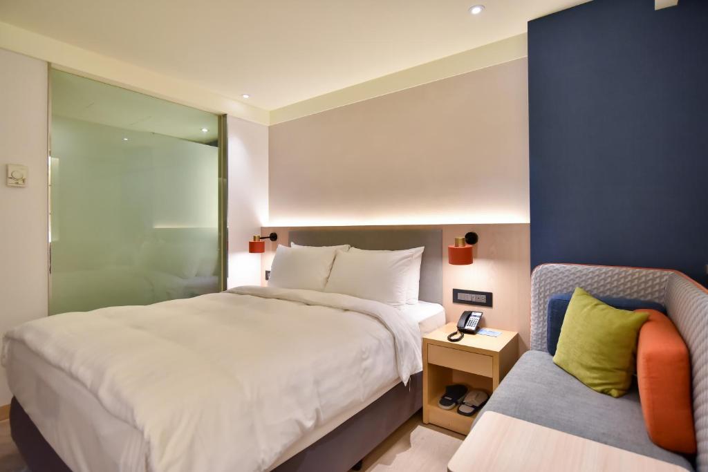 Postel nebo postele na pokoji v ubytování Holiday Inn Express Taipei Train Station by IHG
