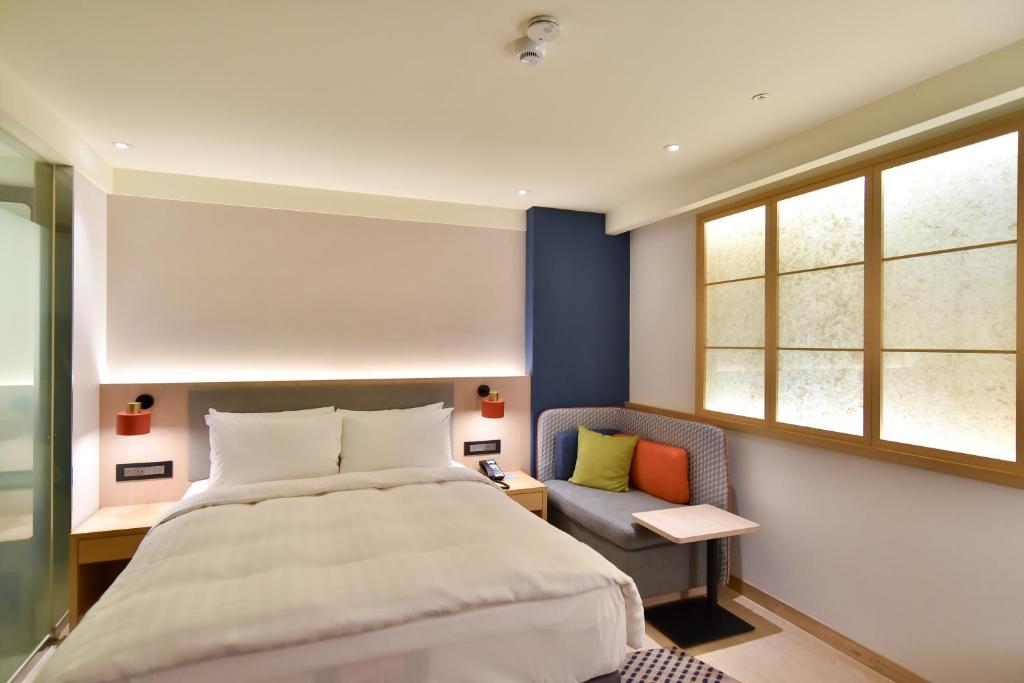 Postel nebo postele na pokoji v ubytování Holiday Inn Express Taipei Train Station by IHG