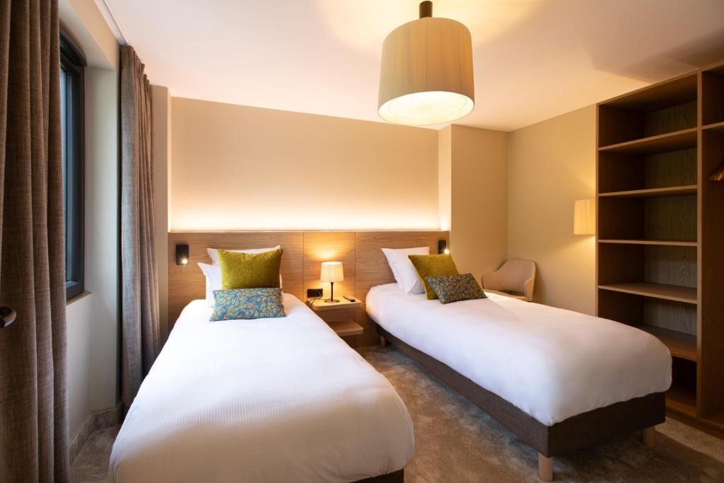 Postel nebo postele na pokoji v ubytování Hôtel Terra Vinum