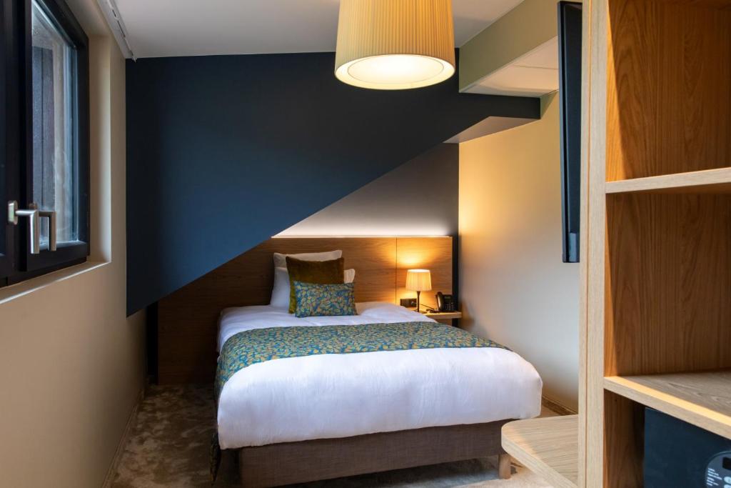 Postel nebo postele na pokoji v ubytování Hôtel Terra Vinum