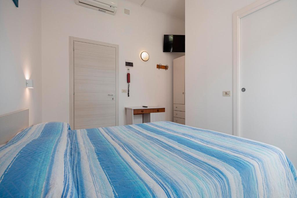 Postel nebo postele na pokoji v ubytování Hotel Flora