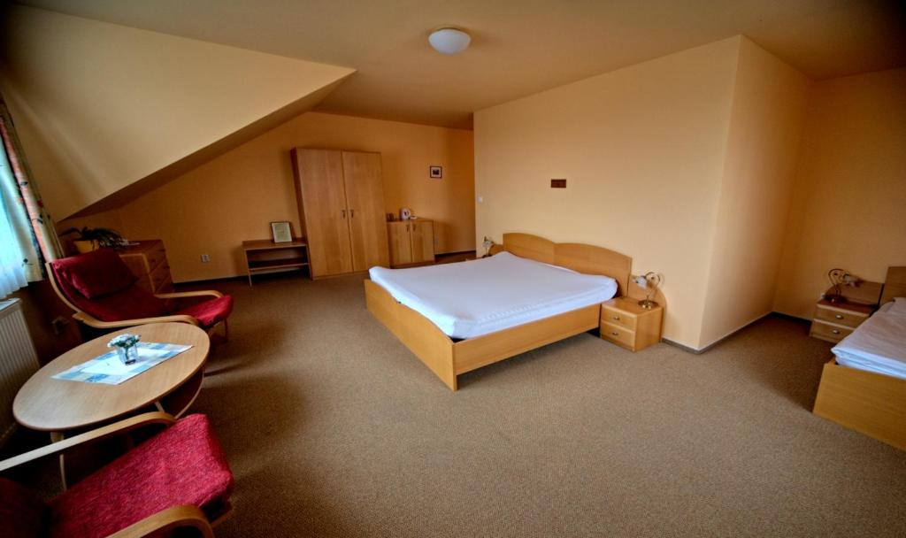Postel nebo postele na pokoji v ubytování Motel U Krbu