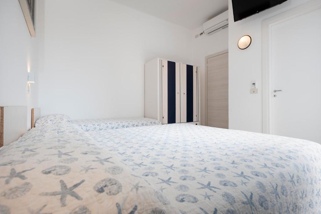 Postel nebo postele na pokoji v ubytování Hotel Flora