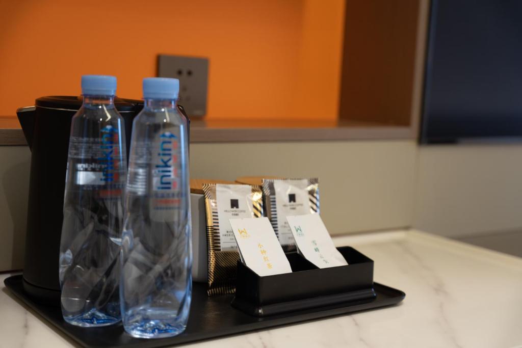 two bottles of water sitting on top of a counter at 沃德酒店济南经十东路融创文旅城店 in Jinan