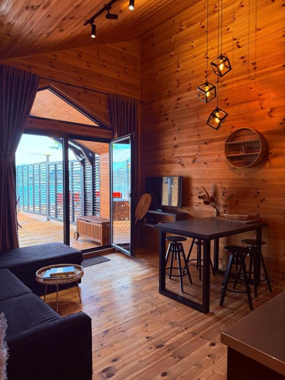 a living room with a couch and a table at Ada Bojana Beach House I XXL TerraceI BBQ I Betw BridgeBeach I Air Con in Ulcinj