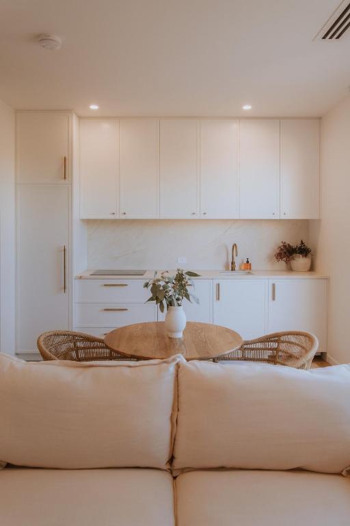a living room with a couch and a table at Villa Alora in Exmouth