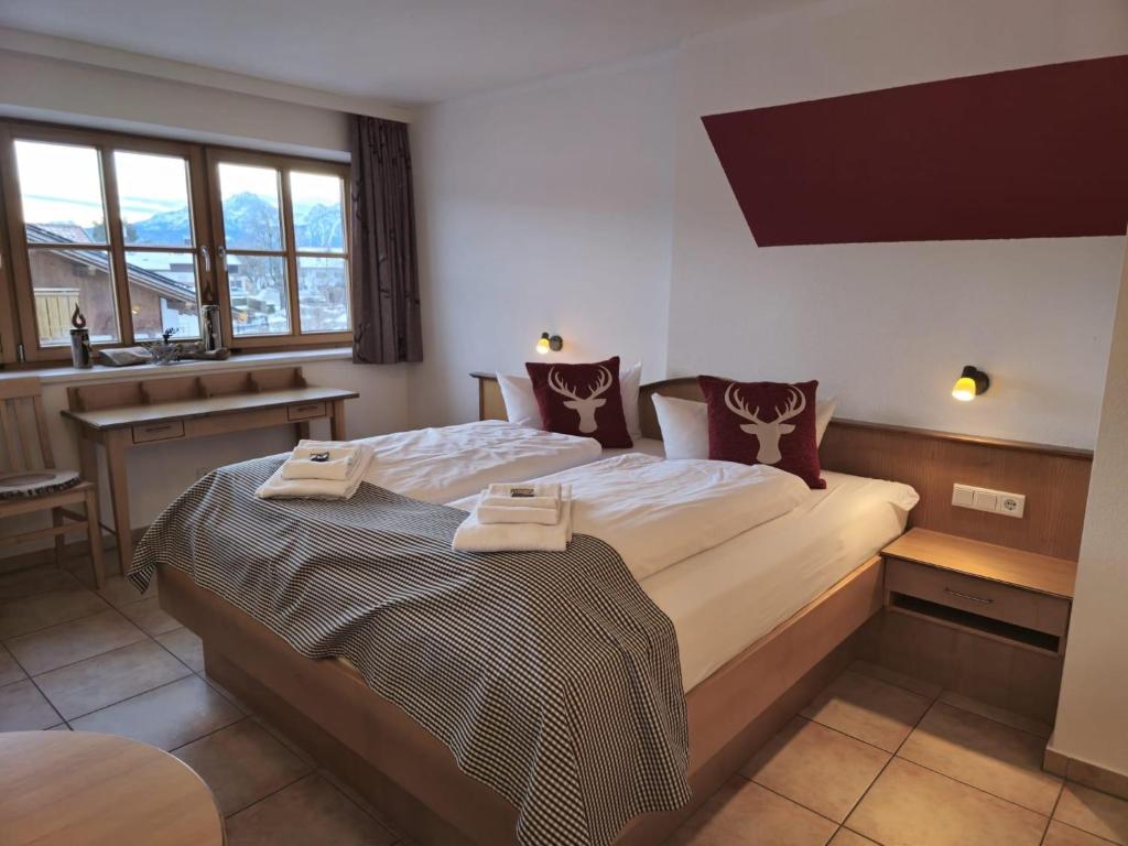 a bedroom with a large bed with towels on it at Ferienhof Haug in Rieden am Forggensee