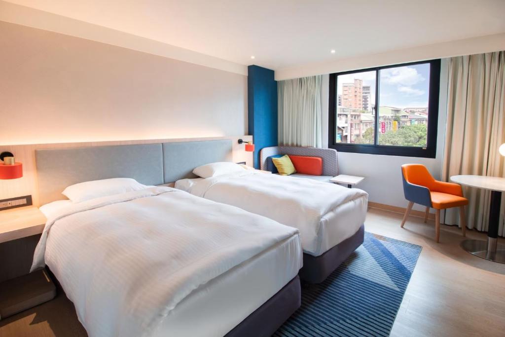 Postel nebo postele na pokoji v ubytování Holiday Inn Express Taipei Train Station by IHG