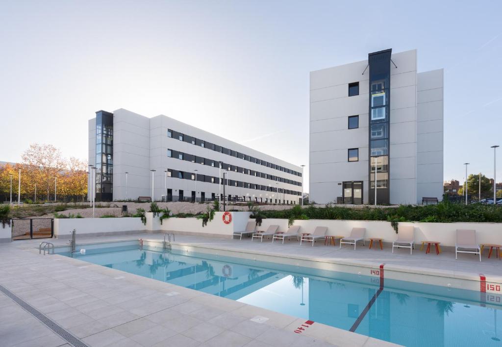 a swimming pool in front of a building at Stephouse Pozuelo Europa in Madrid