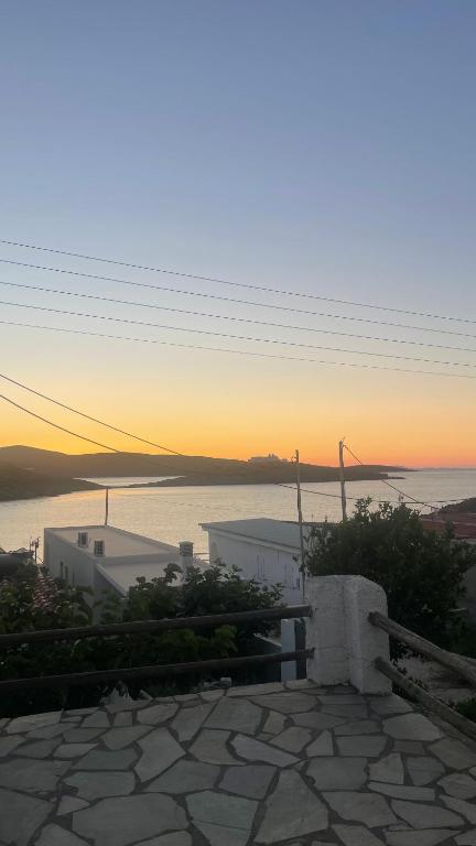 a view of the ocean at sunset from a house at Aosa seaside home in Áyios Stéfanos