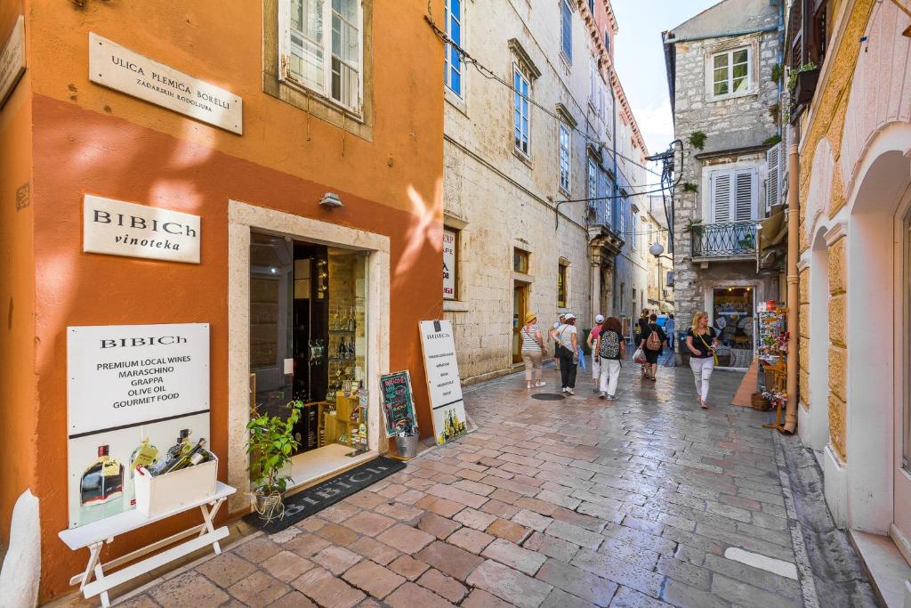 a group of people walking down a street at DeZign Superior Apartments & Rooms in Zadar