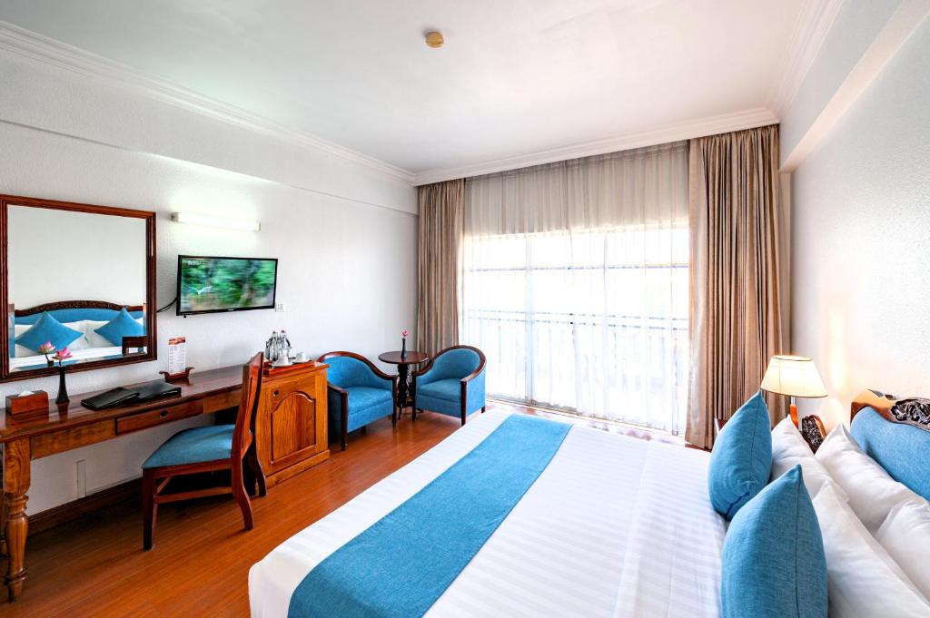 Postel nebo postele na pokoji v ubytování Hotel Somadevi Angkor Resort & Spa