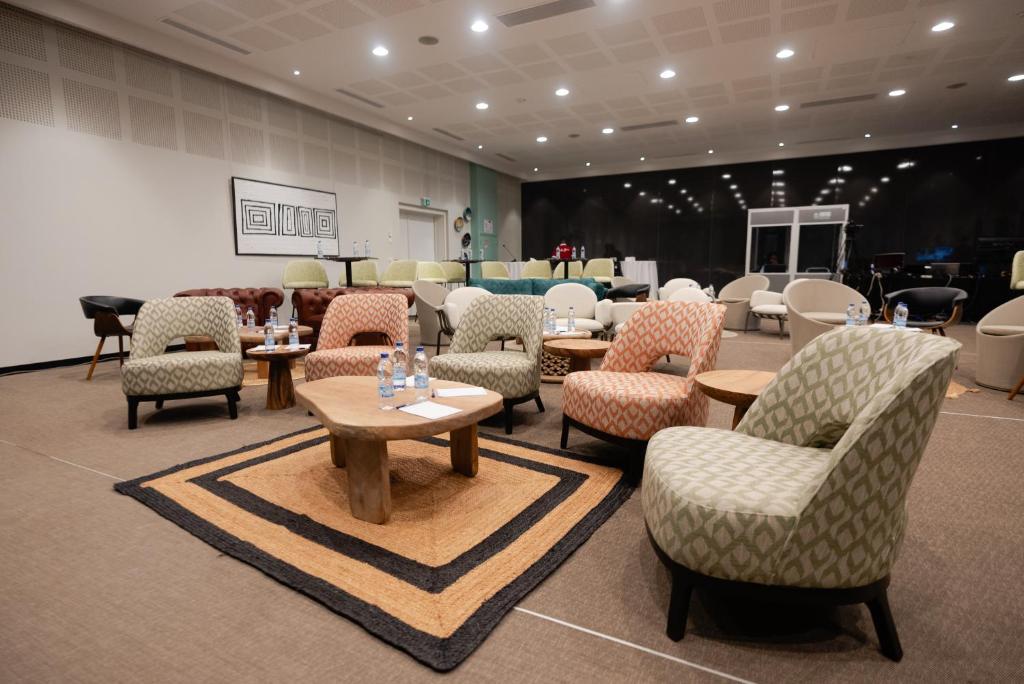 a room with chairs and tables in a store at ONOMO Hotel Abidjan in Abidjan