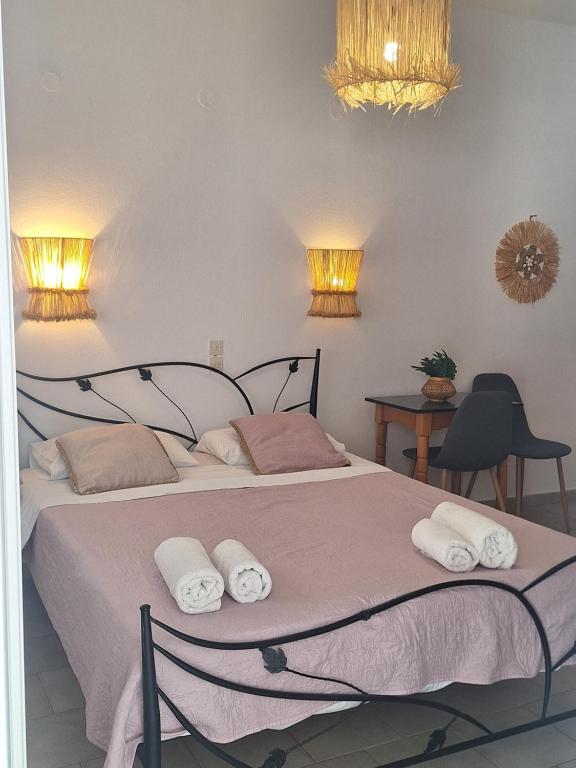 a bedroom with a bed with towels on it at Vithos in Agnontas