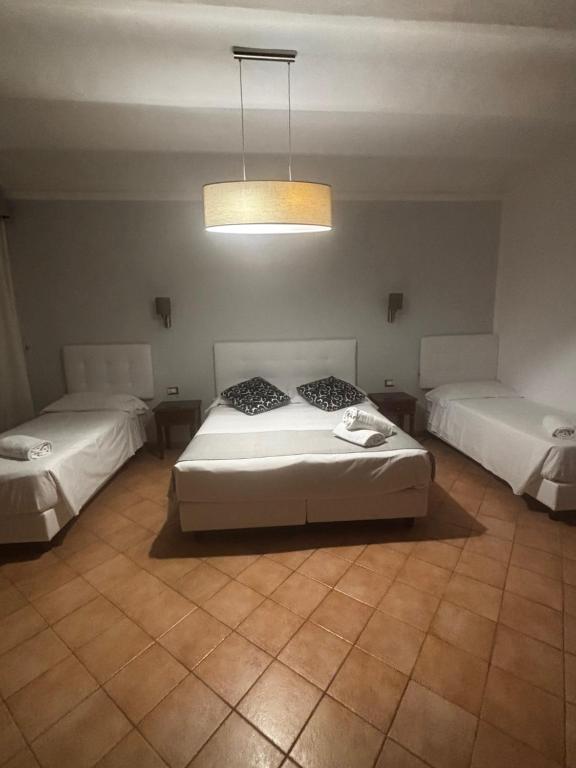 Postel nebo postele na pokoji v ubytování Hotel Gabriella