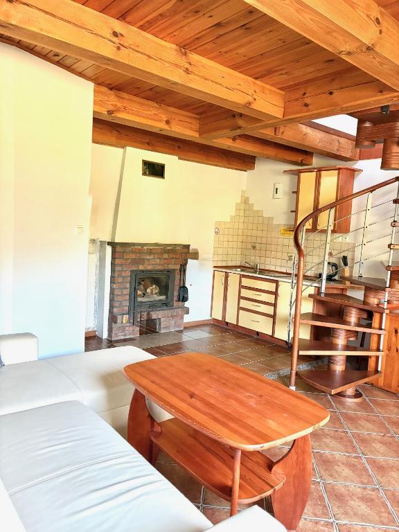 a living room with a table and a fireplace at Camping Morski 21 in Łeba