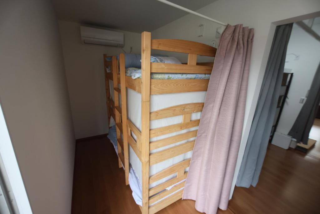 Postel nebo postele na pokoji v ubytování Mount Fuji Omotenashi Guesthouse