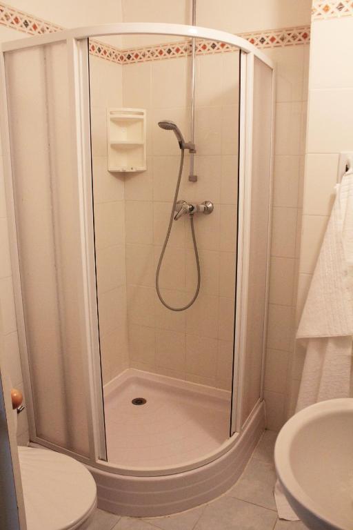 a shower with a glass door in a bathroom at Hotel Orix in Jáchymov