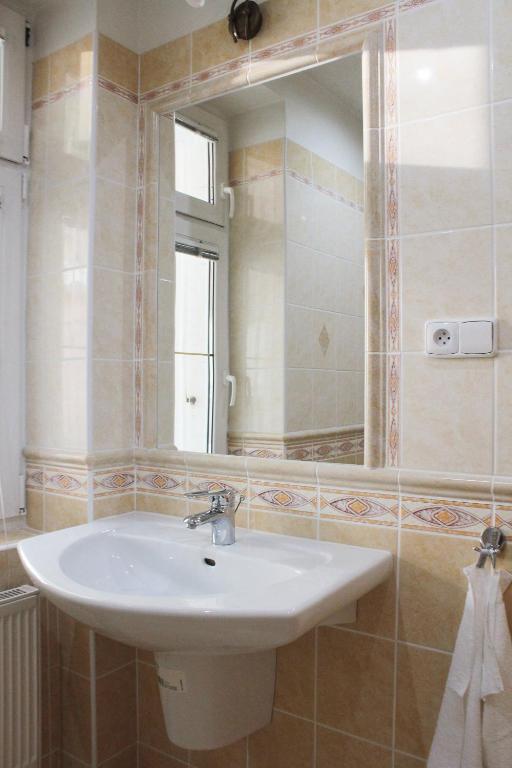 a bathroom with a sink and a mirror at Hotel Orix in Jáchymov