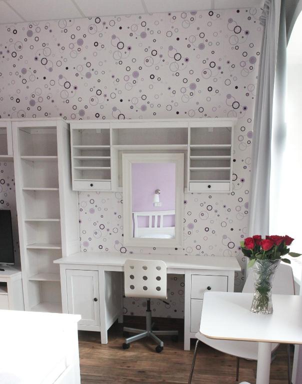 a room with a desk and a mirror at Hotel Orix in Jáchymov