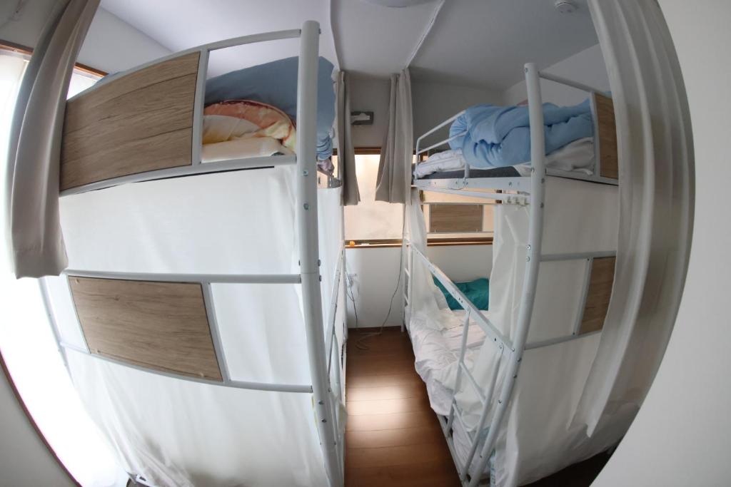 Postel nebo postele na pokoji v ubytování Mount Fuji Omotenashi Guesthouse