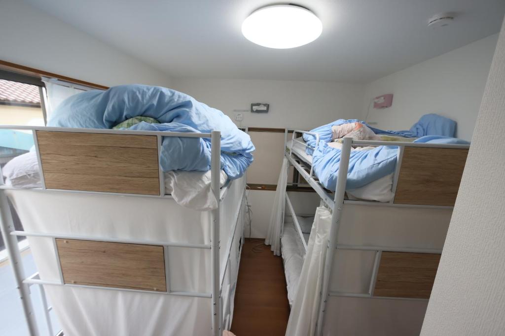 Postel nebo postele na pokoji v ubytování Mount Fuji Omotenashi Guesthouse