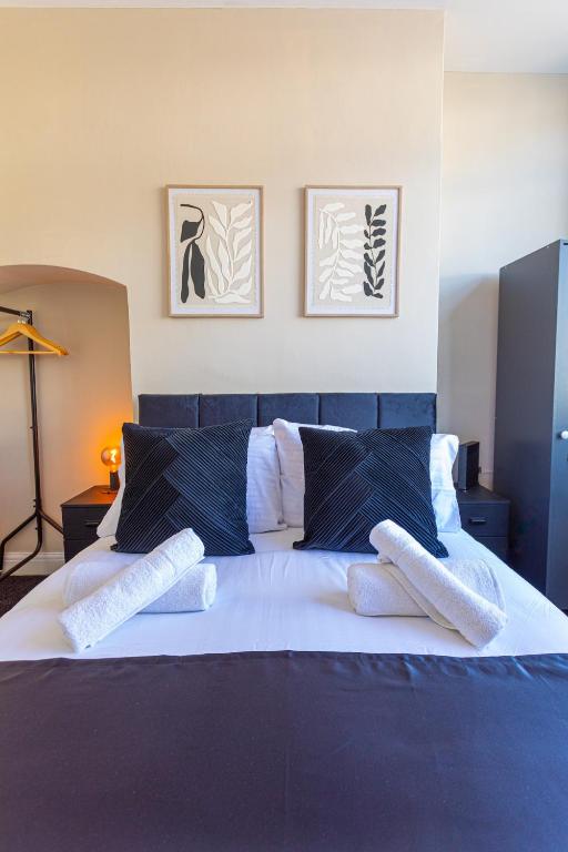 a bedroom with a bed with two white socks on it at Wolverhampton 4 Bed home, Sleeps 7, Parking in Tettenhall