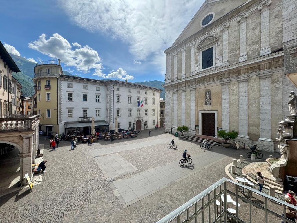 a group of people walking around a courtyard in a building at 1Dest - GardArco in Arco