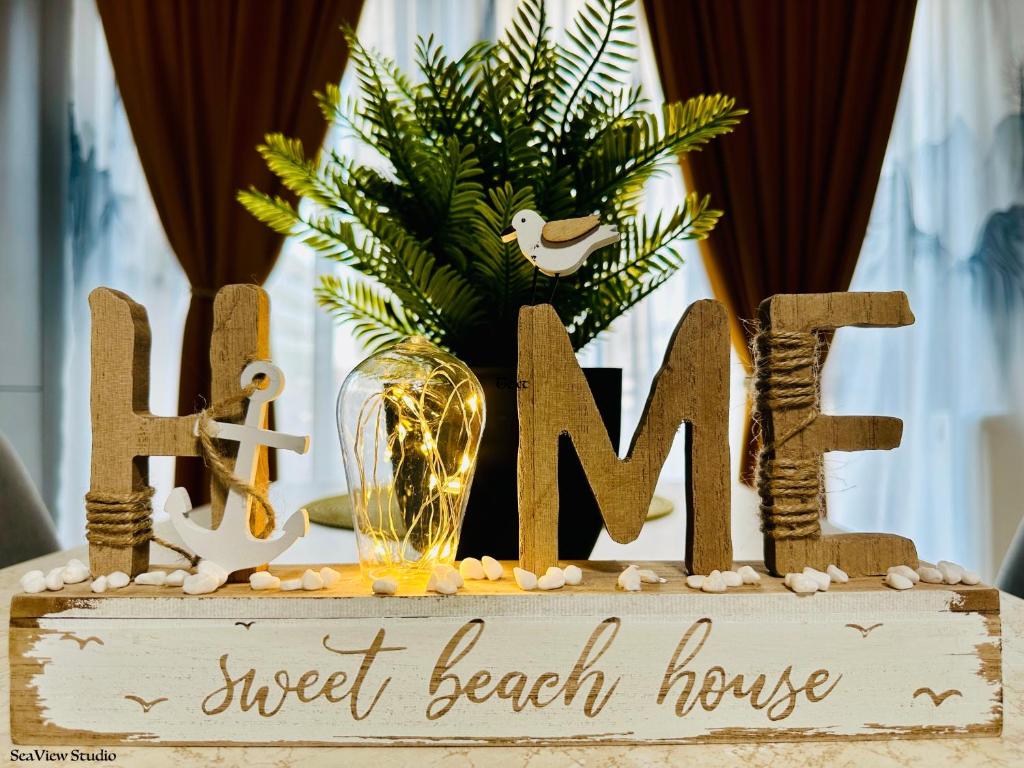 a wooden sign for a sweet beach house at Seaview Studio in Năvodari