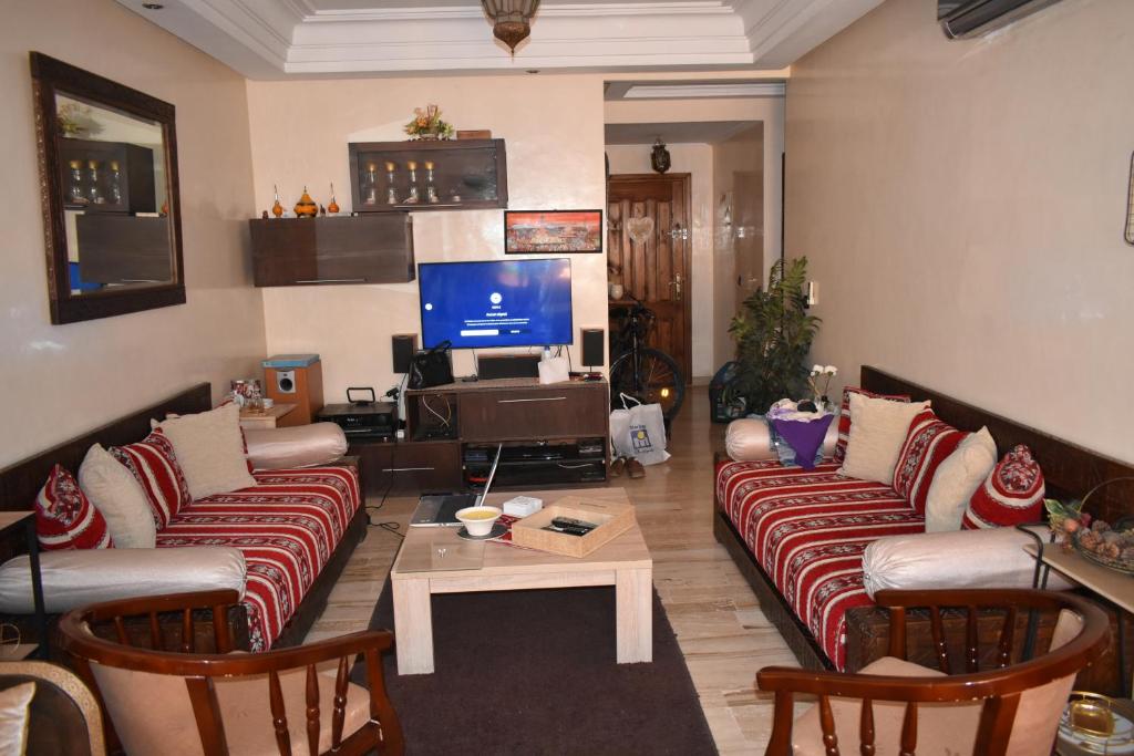 a living room with two couches and a tv at Marrakech Sakan Annakhil im6 n31 in Marrakesh
